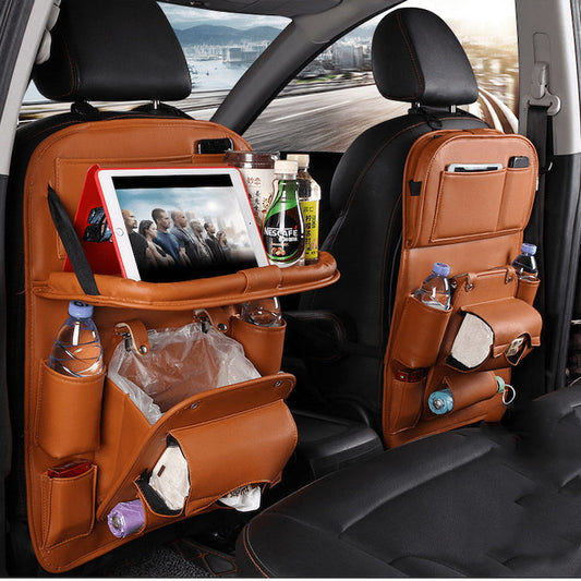 Premium black PU leather car seat back organizer with a foldable dining tray, multiple storage pockets for tablets, bottles, and tissues.