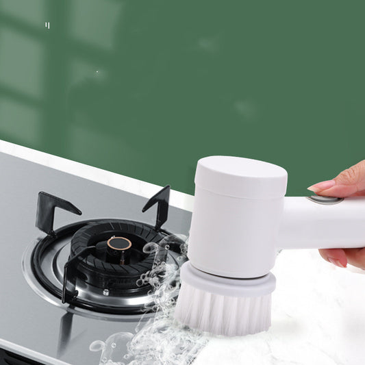 Handheld electric spin scrubber with a white brush head cleaning soap scum from bathroom tiles and grout.