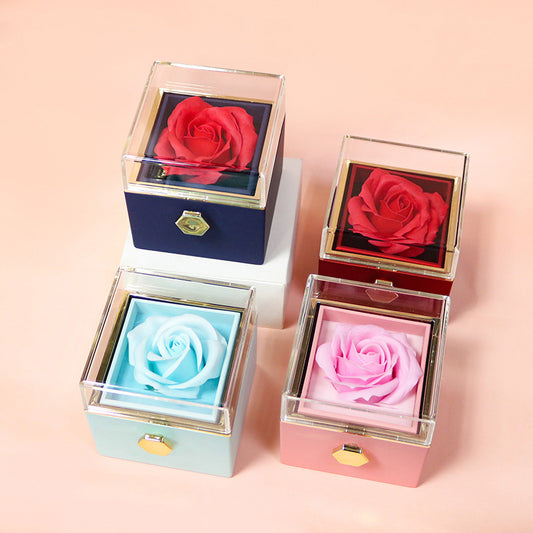 Elegant rotating rose jewelry gift box featuring an eternal red soap flower with a hidden compartment for necklaces or rings.