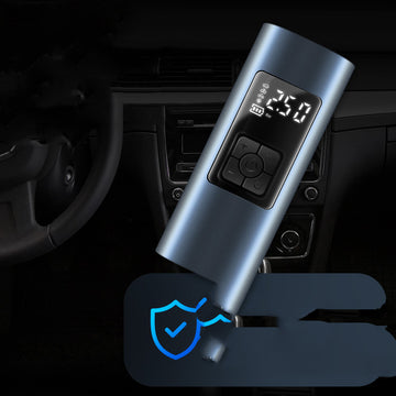 Handheld wireless portable tire inflator with digital LCD pressure gauge showing air pressure while inflating a car tire at night.