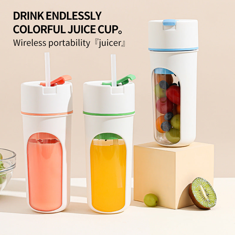 Compact portable wireless blender with a pink lid and clear bottle, blending fresh fruit smoothies for travel and office use.