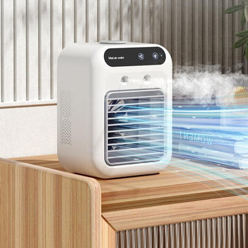 Compact white portable air cooler on a wooden desk, emitting a cool mist with blue LED lighting in a modern office setting.