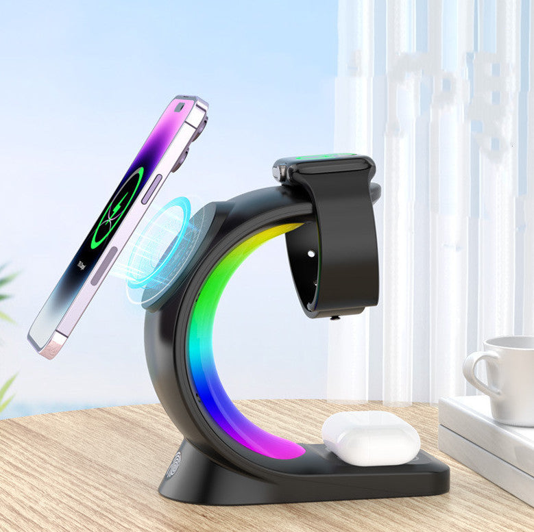 Multi-device charging stand with smartphone, smartwatch, and wireless earbuds on a desk.