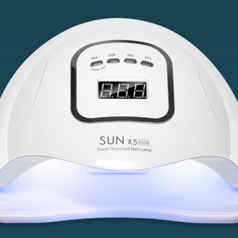 White nail lamp with digital display on a dark blue background