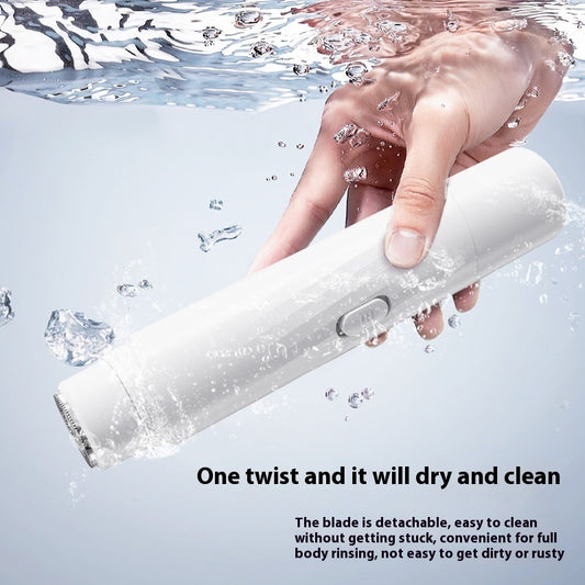 Sleek electric body groomer with ceramic blades and LED light, being used under running water for a safe and close shave.